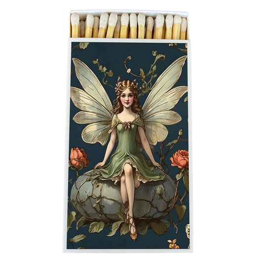 A matchbox-style product with a printed fairy illustration on the front, shown open with wooden matches visible at the top against a plain white background.