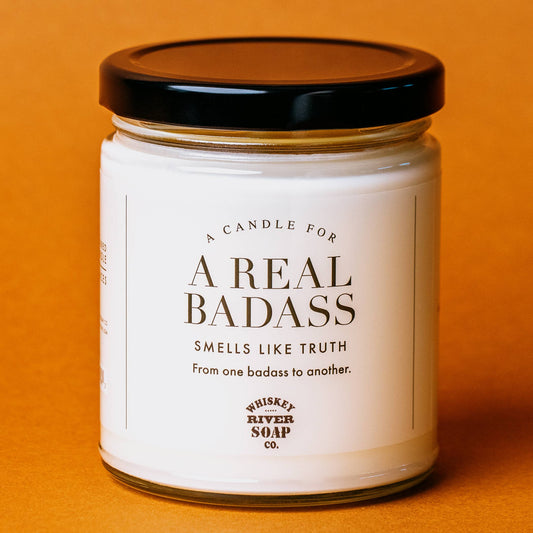 Candle jar with a label on an orange background