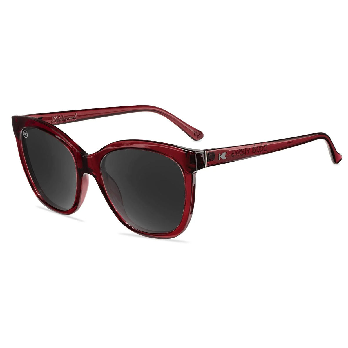 Reddish Maroon Knockaround cats eye sunglasses with a white background.
