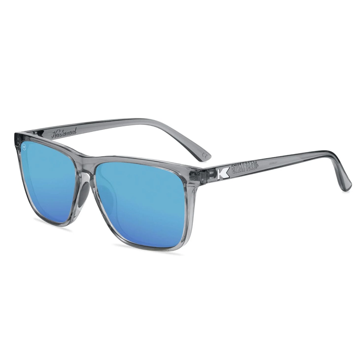 Gray translucent square KNOCKAROUND sunglasses with blue  lenses, shown at a three-quarter angle on a white background.