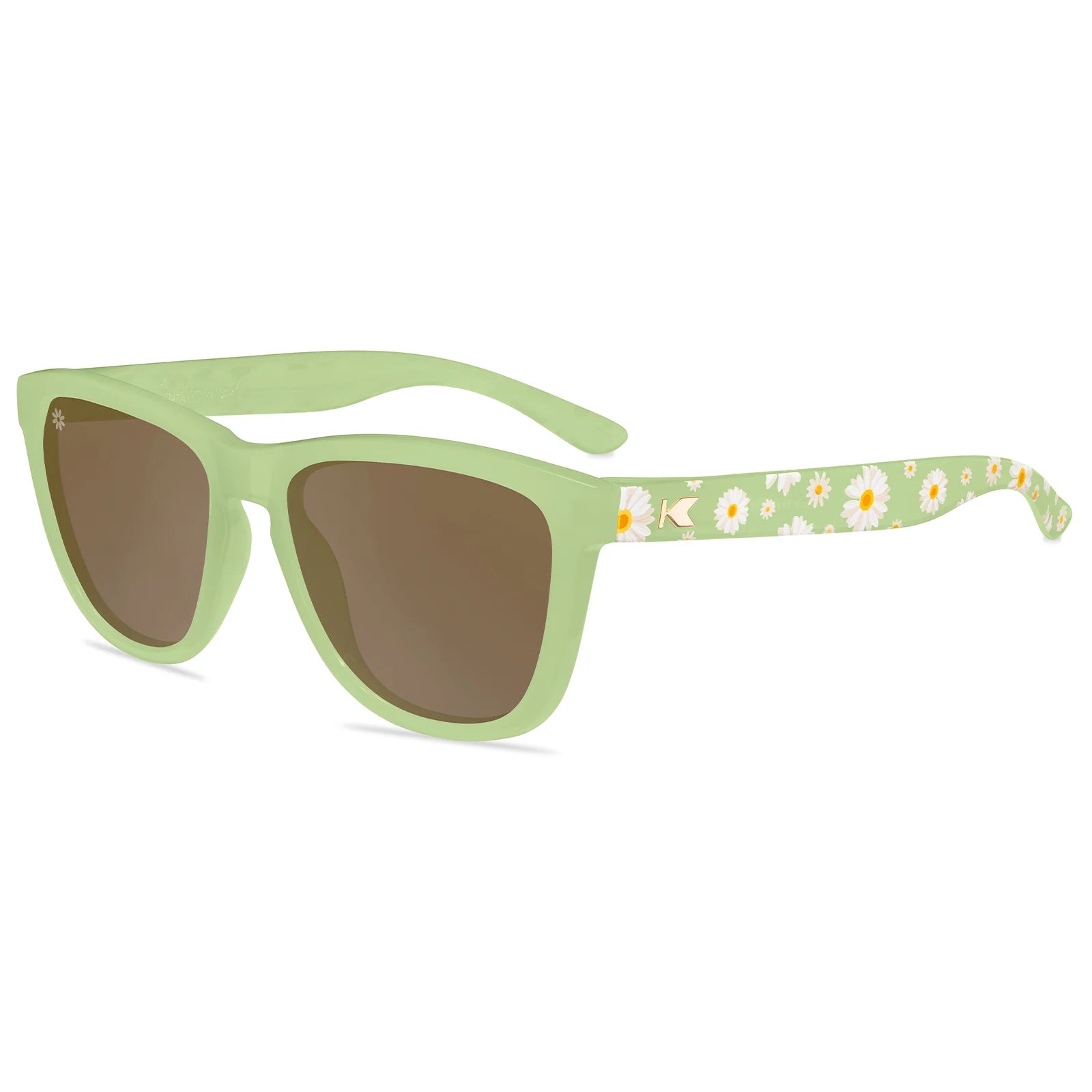 Green Knockaround sunglasses with floral patterned arm on a white background