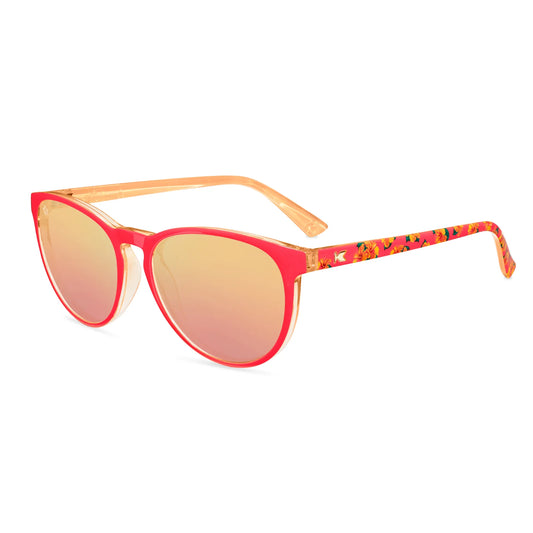 Sunglasses with red frame and yellow-tinted lenses on a white background