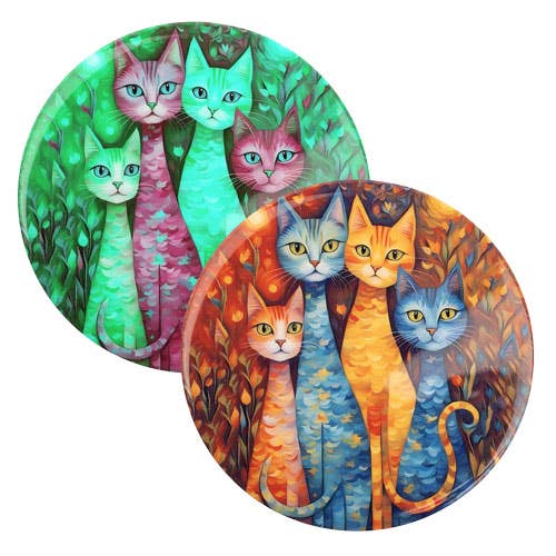 Two round decorative coasters featuring colorful painted cats in autumn foliage, shown overlapping on a white background.