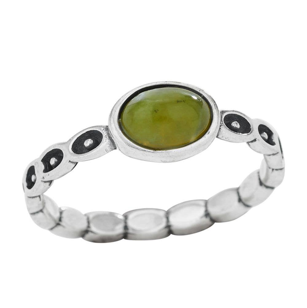 Silver ring with a green gemstone on a white background
