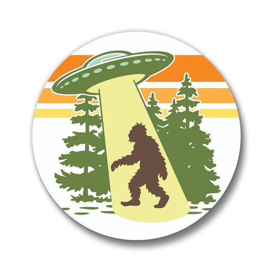 Circular magnetic bottle opener with a UFO and Bigfoot silhouette against a sunset background