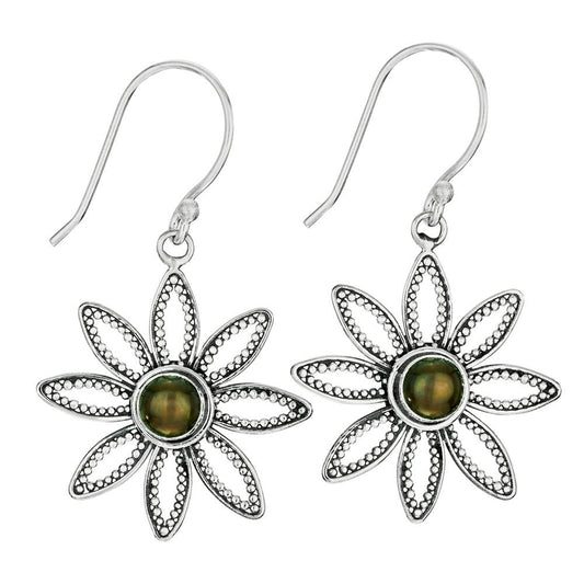 Floral silver earrings with green gemstones on a white background