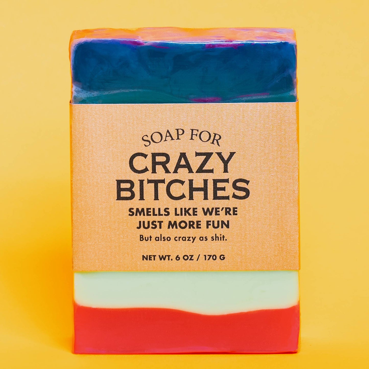 Bar of soap with a colorful packaging label and humorous text on a yellow background