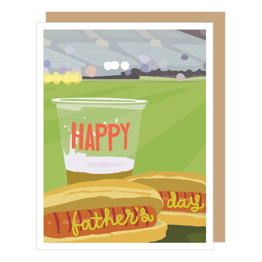 Greeting card with hot dogs and a cup labeled 'Happy Father's Day' on a grassy field background.