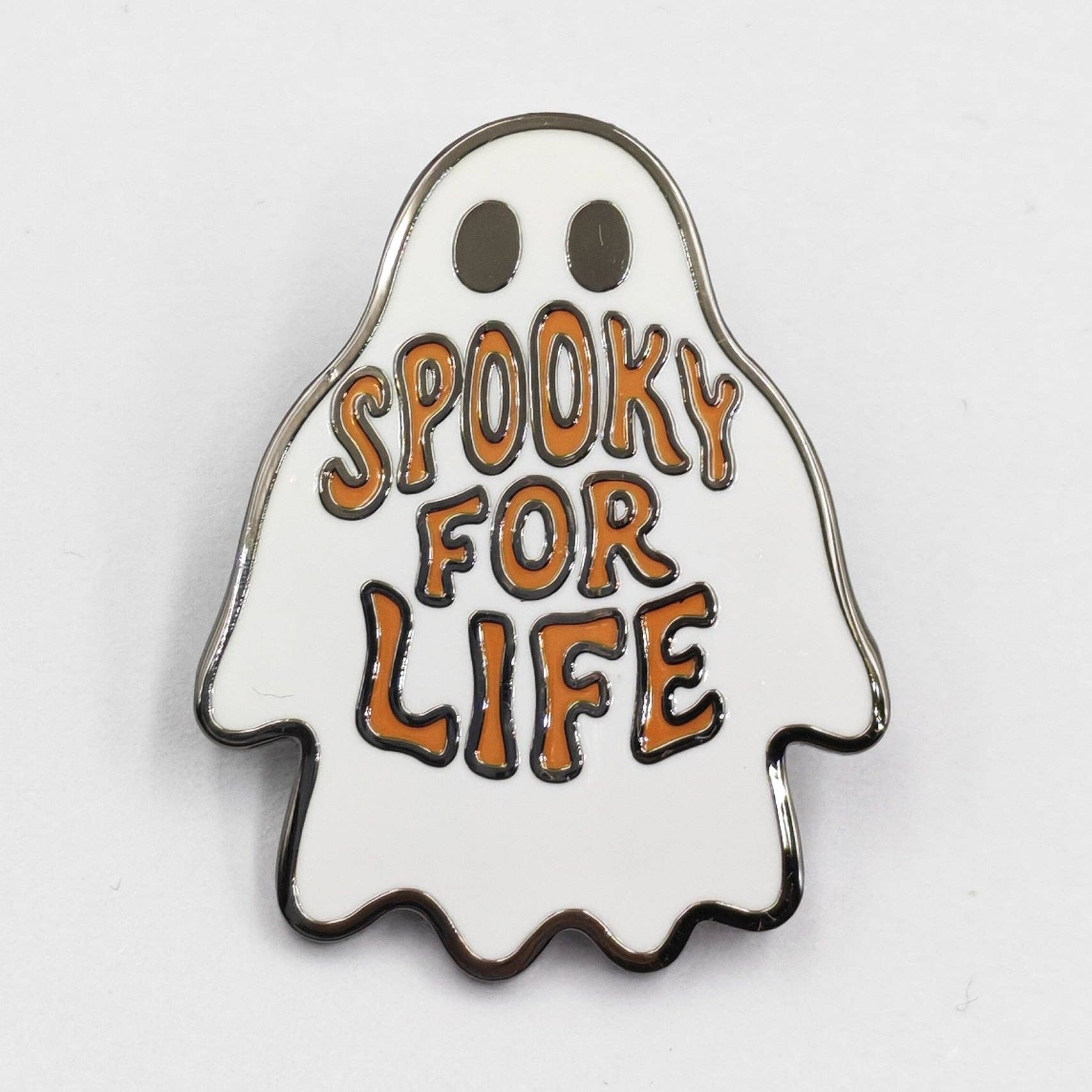 Ghost-shaped enamel pin with 'Spooky for Life' text on a white background